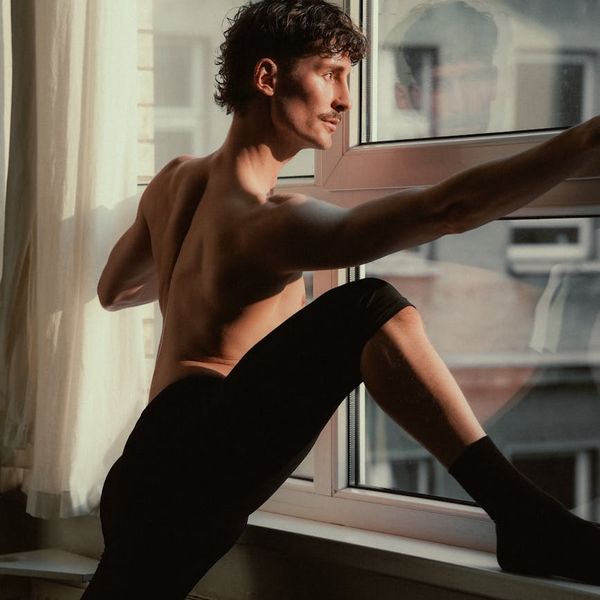 Silhouette of a man stretching with a calm and focused expression.